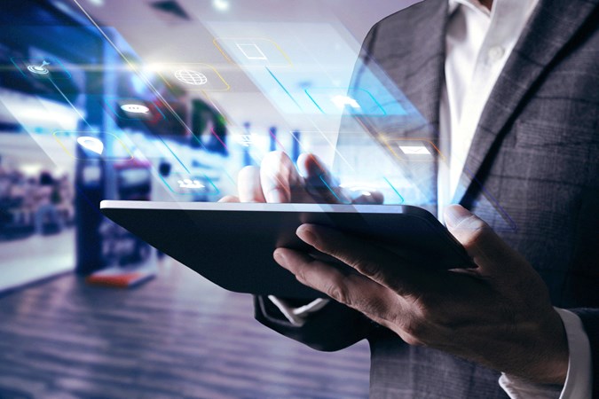 Man using Tablet at work with digital screen reflection