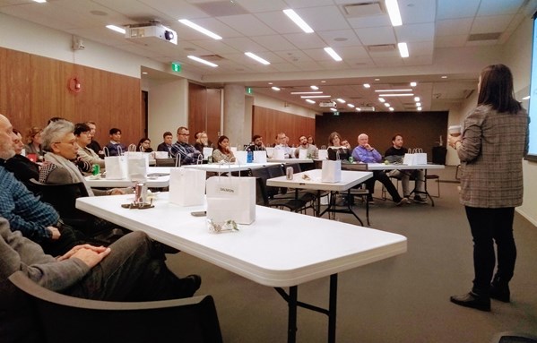 Attendees listen while Christina Lomazzo speaks on the Hype and Hope of Blockchain and Cryptocurrency for Social Good