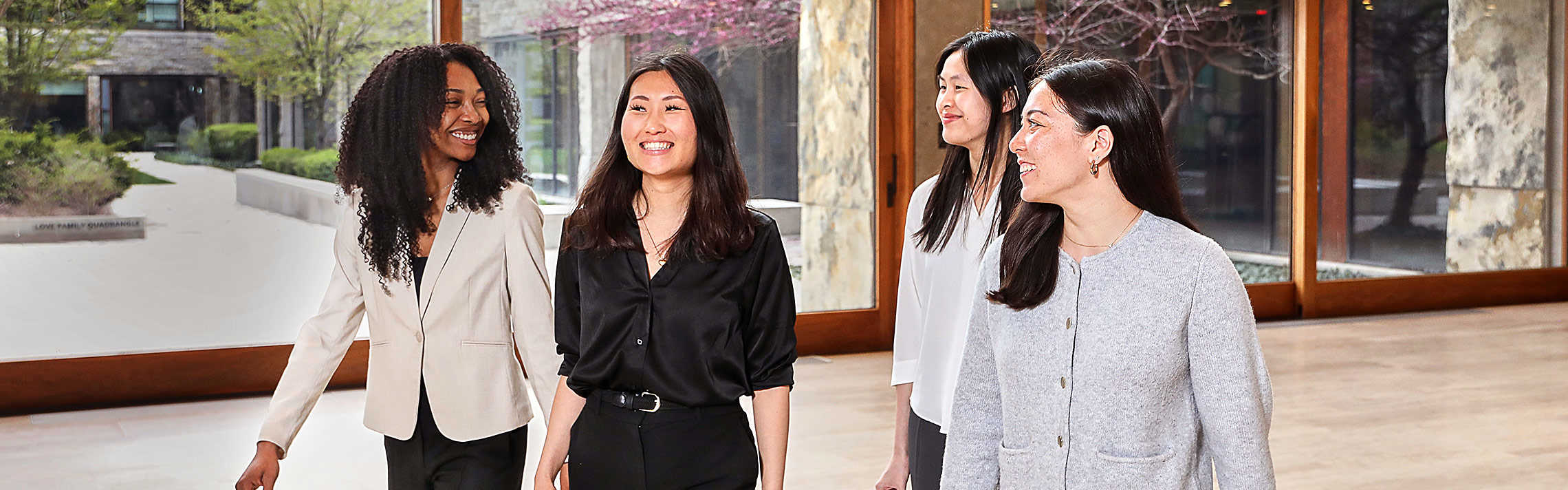 Students walking through the halls of Ivey, talking