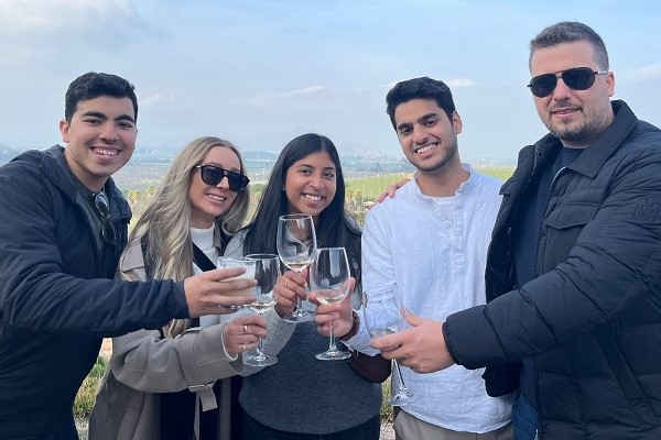 AMBA participants holding glasses of wine at Kingston Vineyards