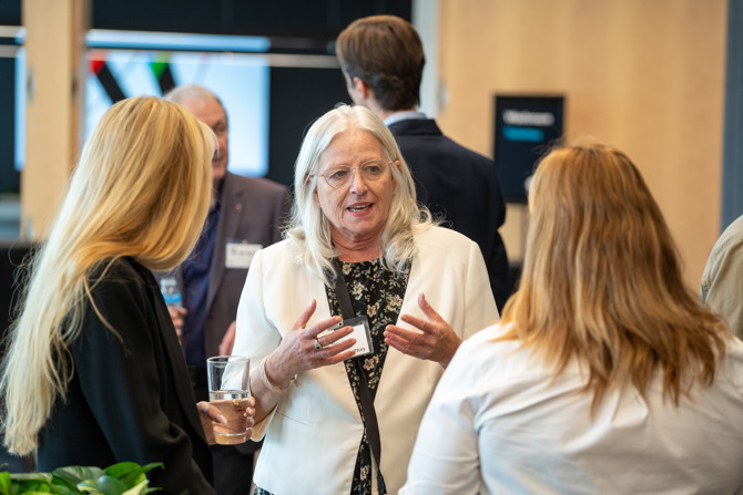 Attendees networking at the event