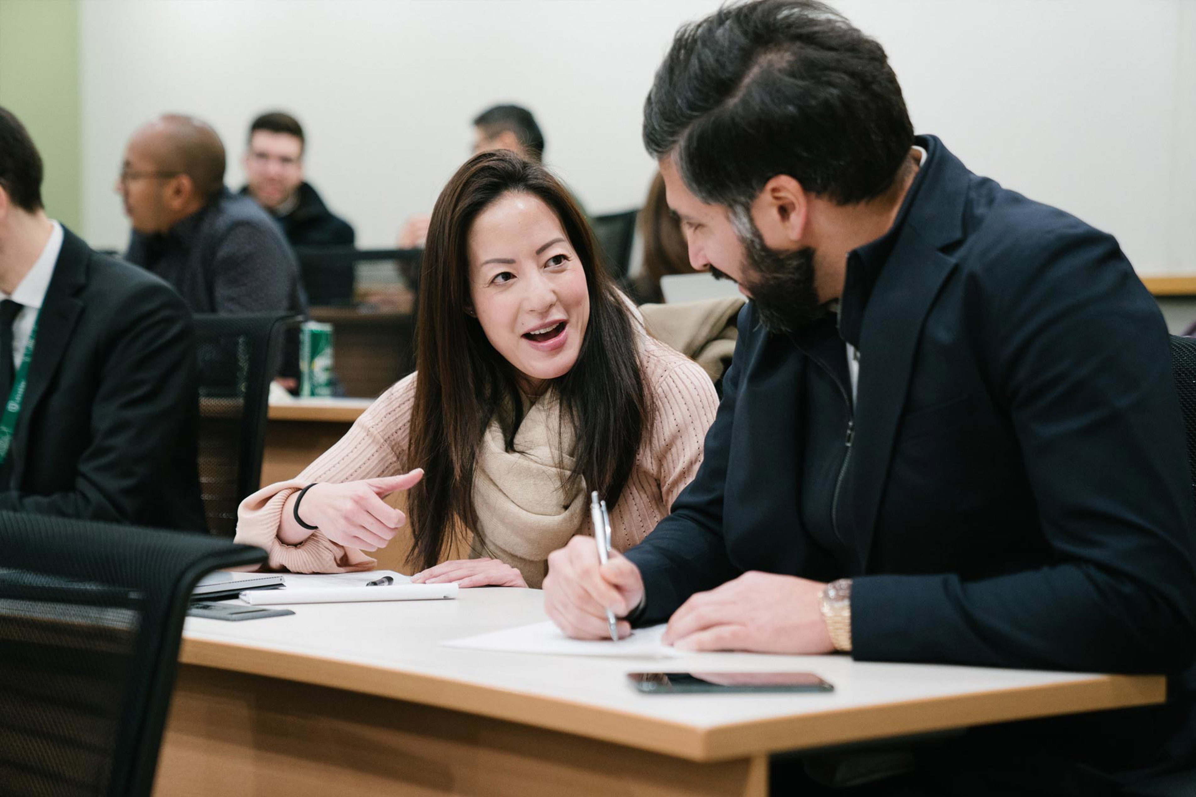 Two Young Professionals Engaged In Conversation During An Ivey Class