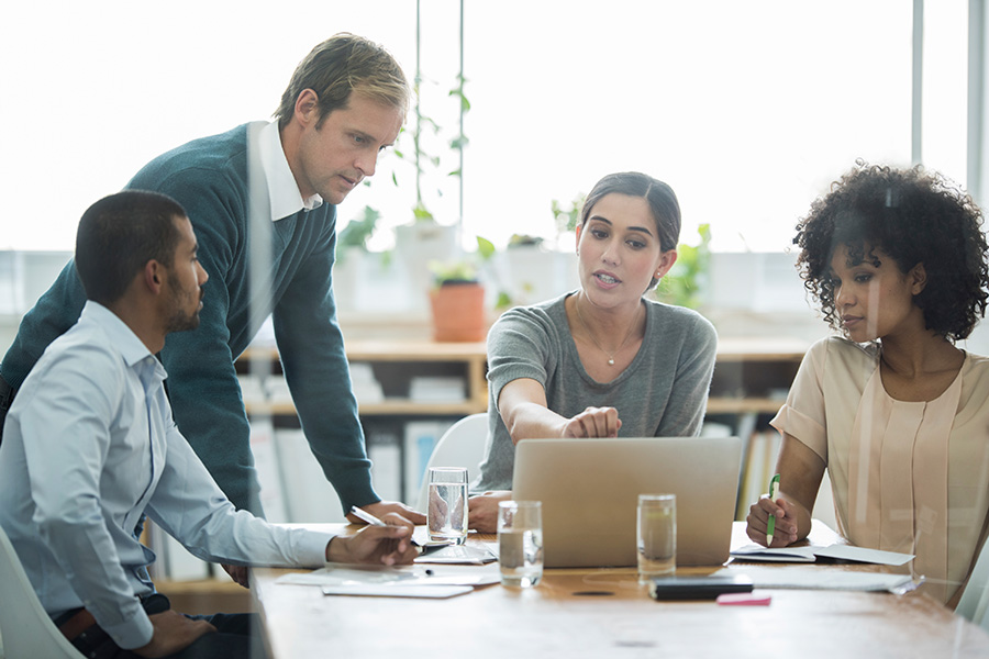 Four people meeting around a table