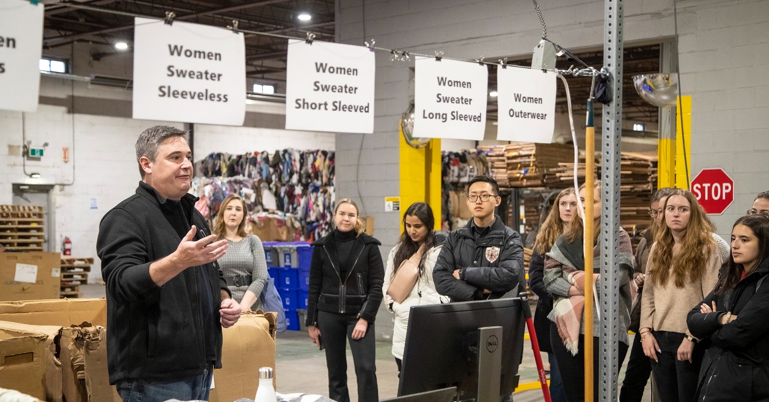 Visiting CEMS MIM students touring Goodwill Industries